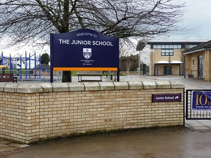 An image of a primary school post and panel sign.